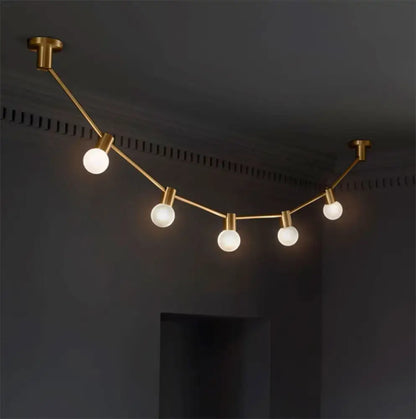Modern gold frosted glass wall light with five bulb bases on curved arm suitable for 110v 120v 220v 240v use