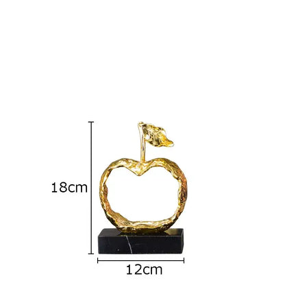 Modern gold fruit shaped metal crafts apple sculpture with textured surface and leaf on black marble decorbites base