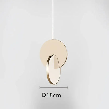 Modern gold geometric circle pendant light with two overlapping discs in matte beige and polished gold metal for dining room decorbites geometric circle