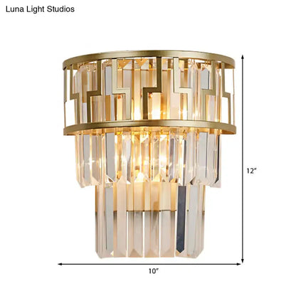 Modern gold geometric wall lamp with cascading clear crystal prisms and metal framing sconce fixture for bedroom