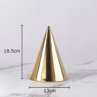 A sleek glossy gold cone-shaped modern cube round statue with smooth reflective surface for living room decor