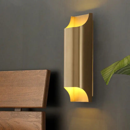 Modern gold geometric led wall sconce with sleek curved design and g9 bulb base providing warm ambient lighting