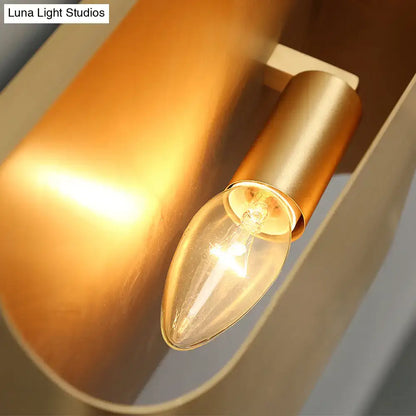 Modern gold geometric led wall sconce with warm-toned brass finish and clear glass candle bulb using g9 bulb base
