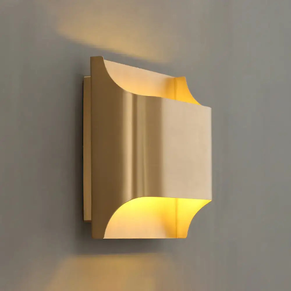 Modern gold geometric LED wall sconce with sleek curved design and g9 bulb base providing warm ambient lighting