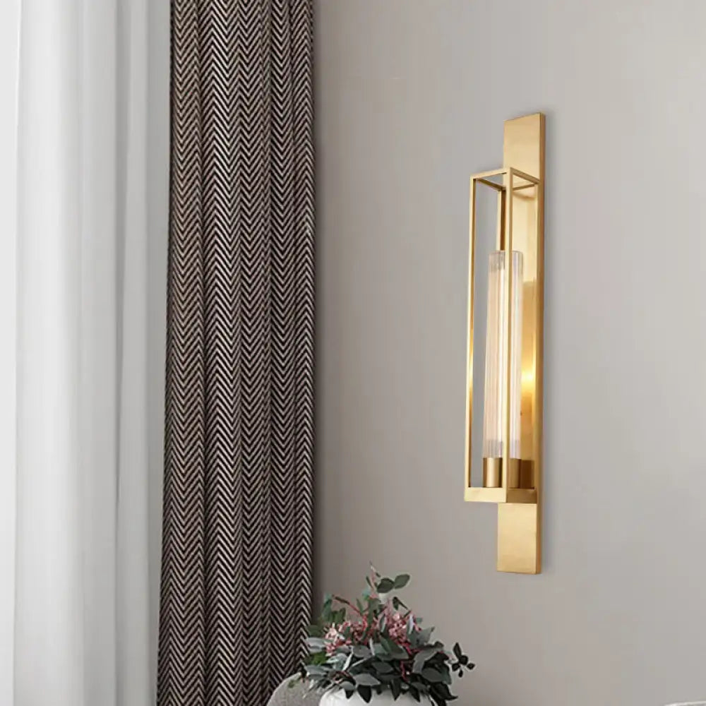 Modern gold wall mount lamp with rectangular geometric metal frame and clear ribbed glass shade for bedroom use