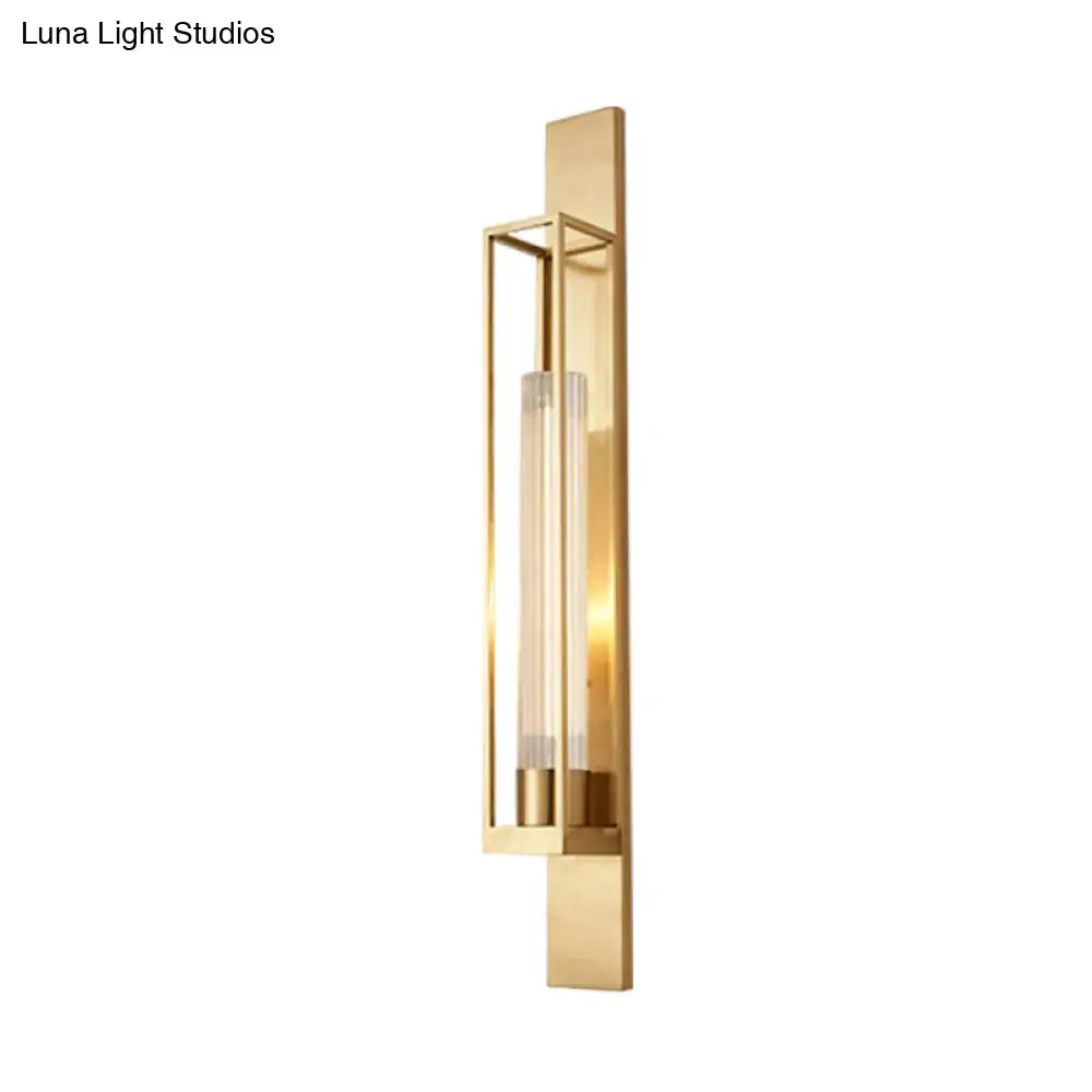 Modern gold wall mount lamp with a sleek rectangular frame and ribbed clear glass shade for bedroom use
