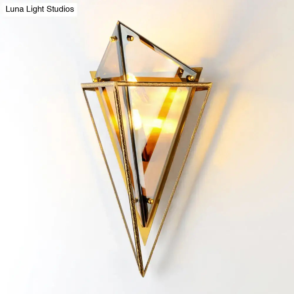 Modern gold geometric wall sconce with brass frame and mirrored glass panels for living room lighting