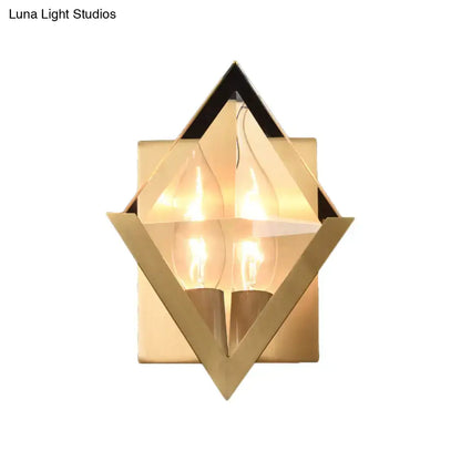Modern style gold geometric wall sconce with clear crystal accents and two exposed filament bulbs for bedroom lighting