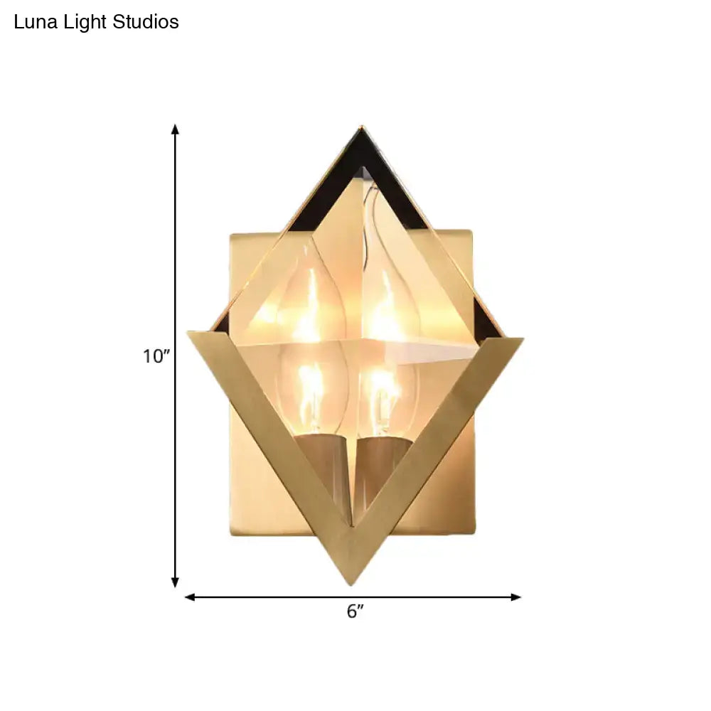 Modern style gold geometric wall sconce with clear crystal accents and two exposed filament bulbs for bedroom lighting