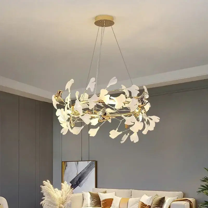 Elegant gold-toned modern ginkgo branch leaf led chandelier with white glass leaves by decorbites for living room decor