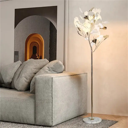 Modern gold ginkgo flower floor lamp with metallic stem and delicate white ginkgo flower lights for living room decorbites decor