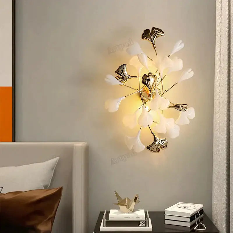 Modern gold ginkgo leaf porcelain wall sconce with delicate white and metallic gold leaf designs for bedroom lighting