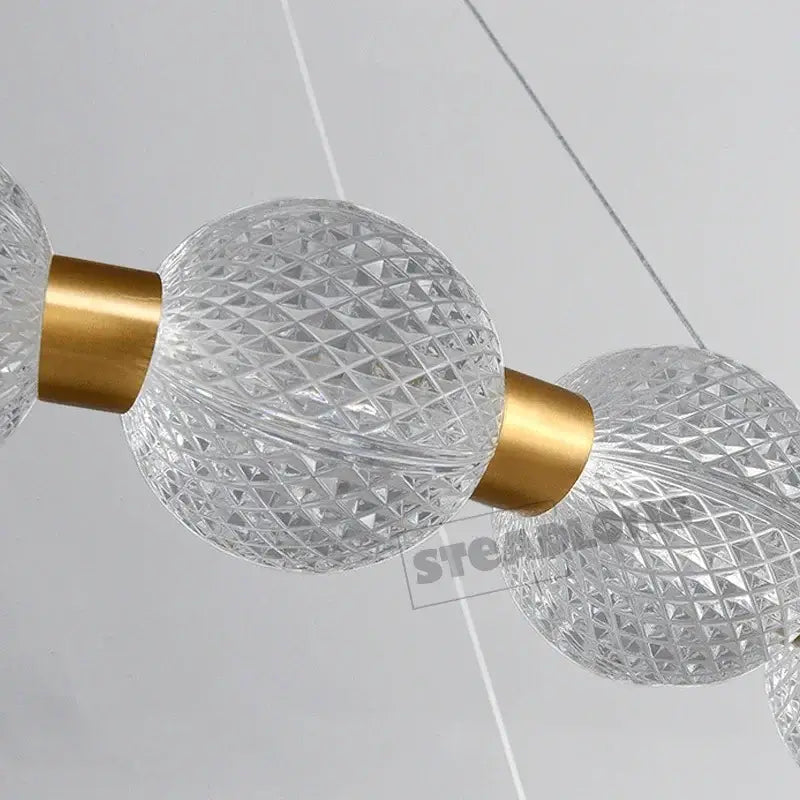 Modern gold glass ball led ceiling chandelier featuring clear faceted glass spheres with gold-toned connectors
