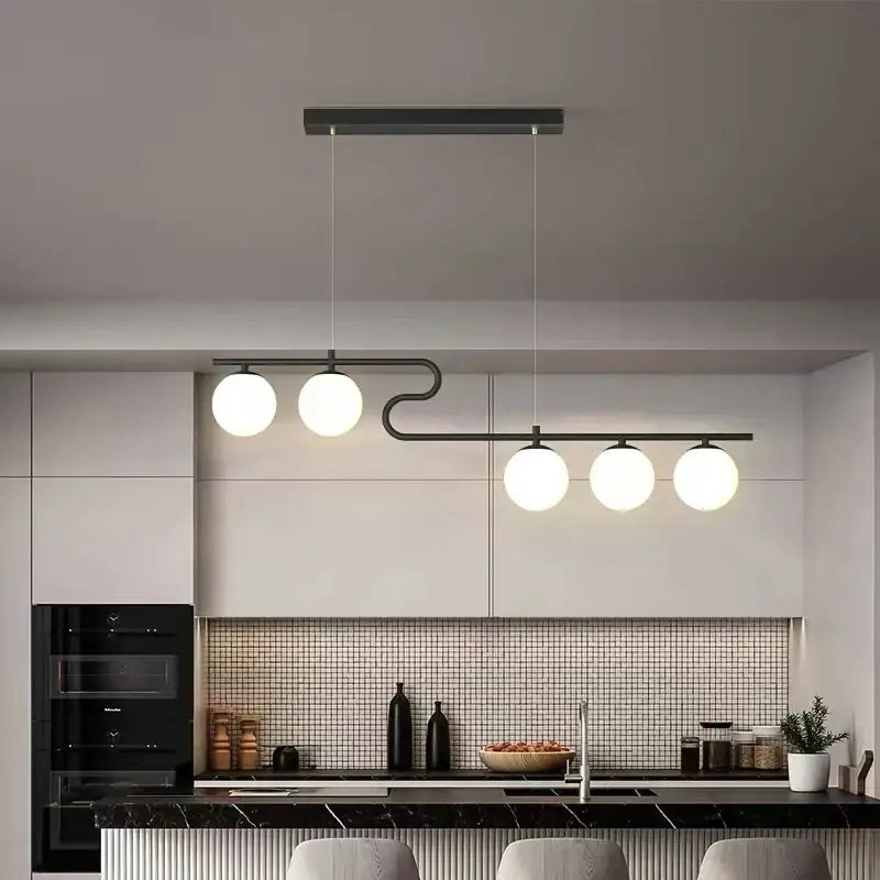 Modern black metal pendant light with four glowing white glass ball led bulbs for decorbites glass ball chandelier design