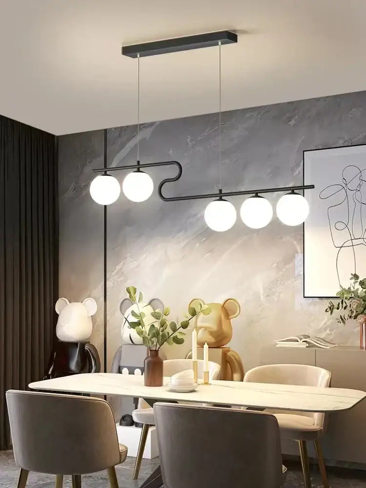 Modern black metal pendant light with five white glass balls for dining room decor featuring decorbites glass ball led design