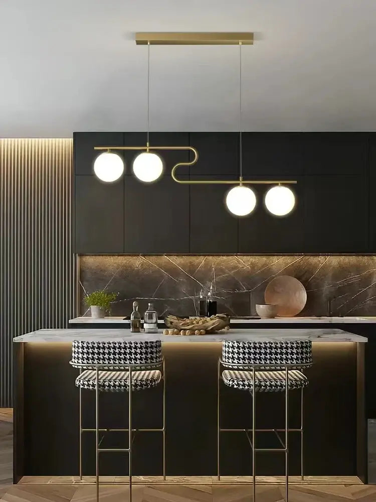 Modern gold glass ball led chandelier with three spherical bulbs and curved metal frame for dining room decorbites glass ball