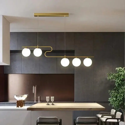 Modern gold glass ball led chandelier with four spherical white glass bulbs in a sleek curved design for dining rooms decorbites glass ball