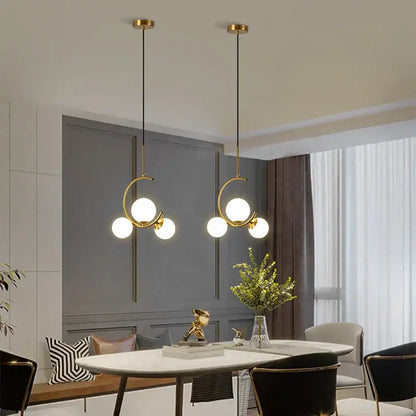 Modern gold glass ball led chandelier features gold-toned circular frames with multiple spherical bulbs for dining room decorbites glass ball pendant light