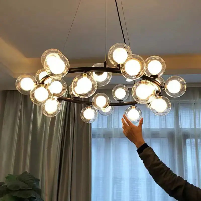 Modern gold glass ball led chandelier with dark metal frame and clear glass globes for dining room decorbites glass ball