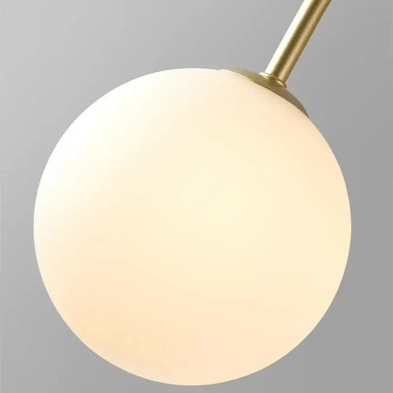 A modern gold decorbites glass ball led chandelier featuring a warm frosted globe lamp for dining room decor