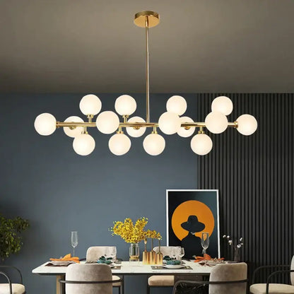 Modern gold glass ball led chandelier with frosted globes in linear branching design for kitchen and dining room decorbites