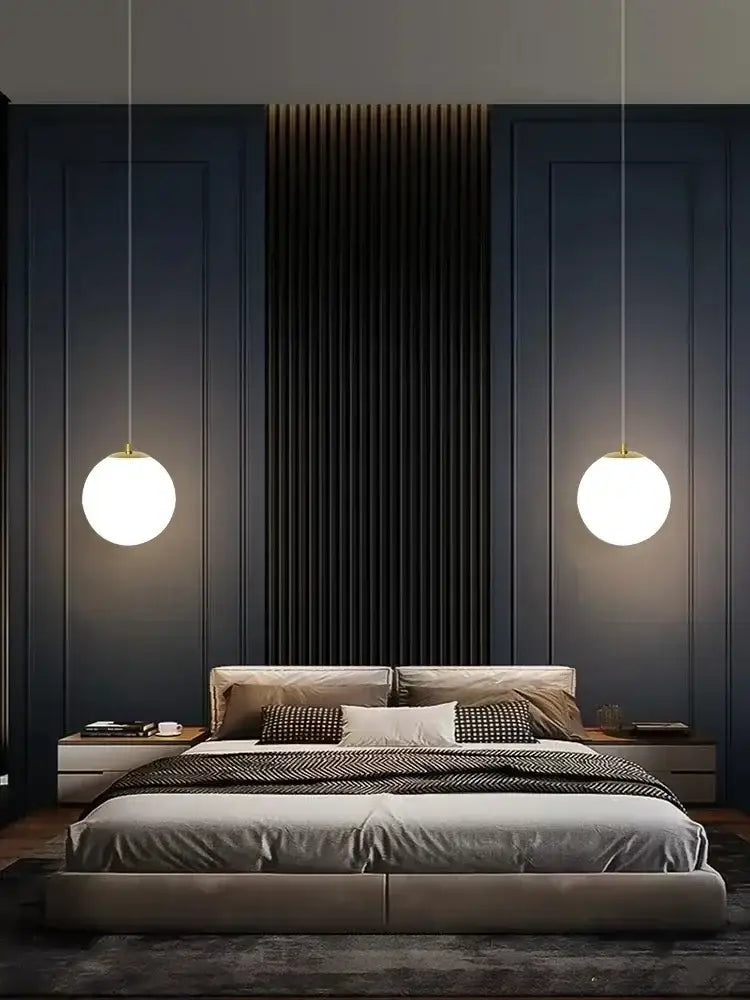 Modern gold glass ball led pendant chandelier with warm white glow and gold-toned decorbites glass ball fixtures above bed