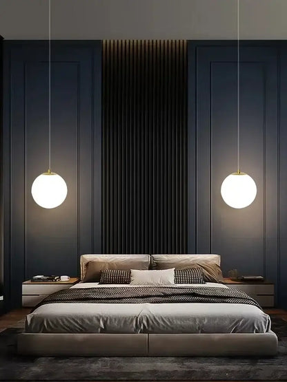 Modern gold glass ball led pendant chandelier with warm white glow and gold-toned decorbites glass ball fixtures above bed