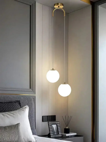 Two frosted glass ball led pendant chandeliers with polished gold fixtures for modern bedroom decorbites lighting