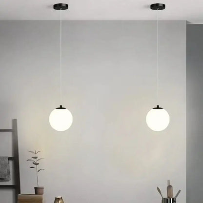 Two minimalist black pendant chandelier lights with spherical white glass ball led shades for bedroom decorbites glass ball