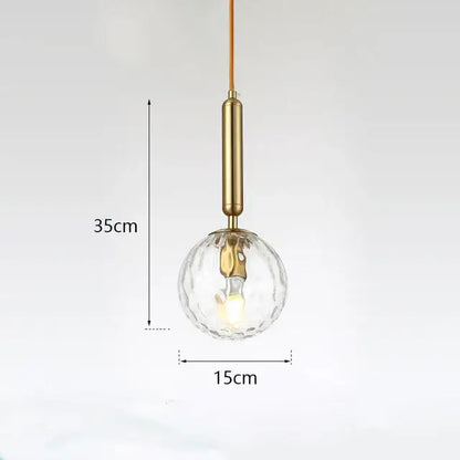 Modern gold glass ball led pendant light with brass cylindrical stem and clear faceted decorbites glass ball globe