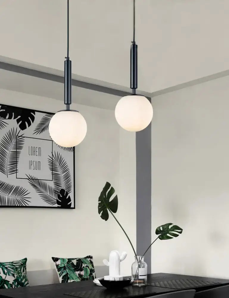 Two sleek black pendant lights with frosted glass ball led shades for modern gold decorbites glass ball pendant light bedroom use