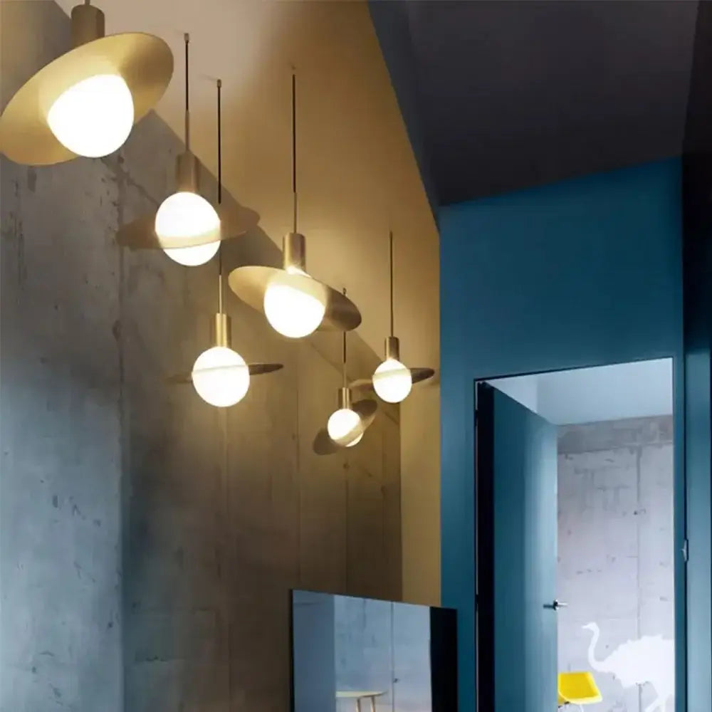 Modern gold pendant light with brass flat disc shades and spherical glass ball led bulbs for dining room decorbites glass ball