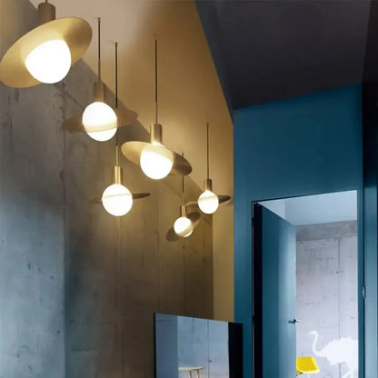 Modern gold pendant light with brass flat disc shades and spherical glass ball led bulbs for dining room decorbites glass ball