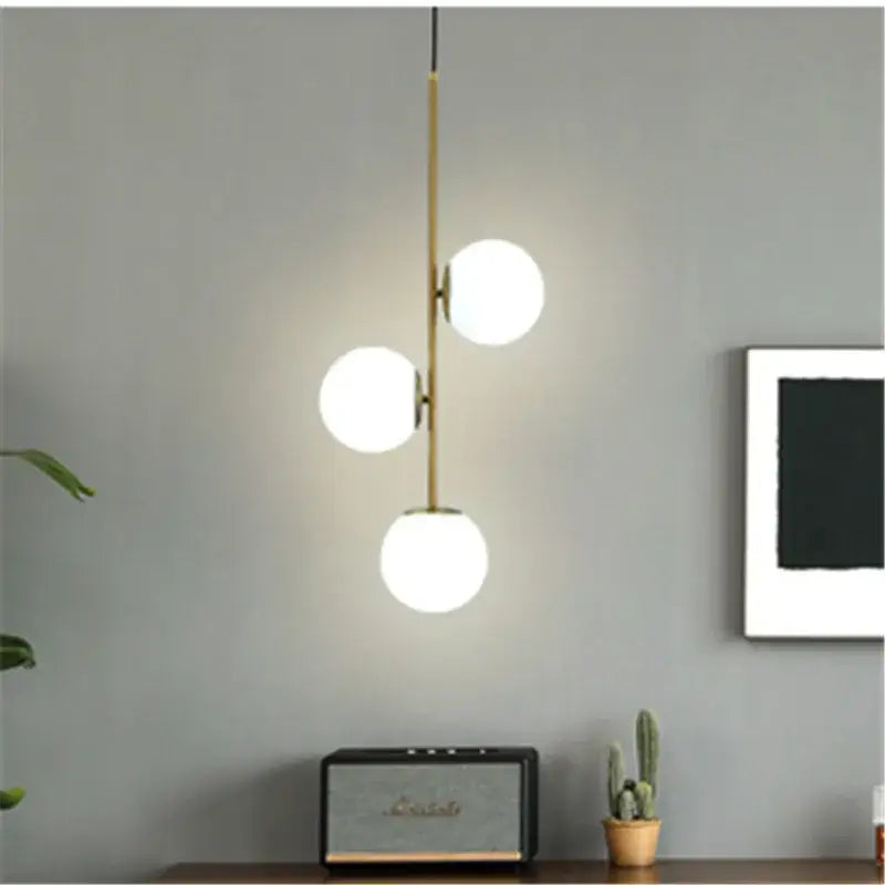 Modern gold glass ball led pendant light with three glowing white spherical glass bulbs for living room decorbites pendant light