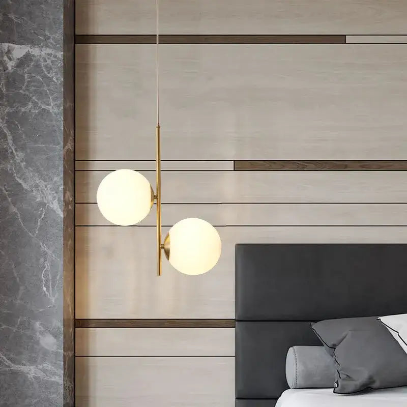 Modern pendant light featuring two frosted glass spheres suspended by a slender brass rod for living room decorbites glass ball led use