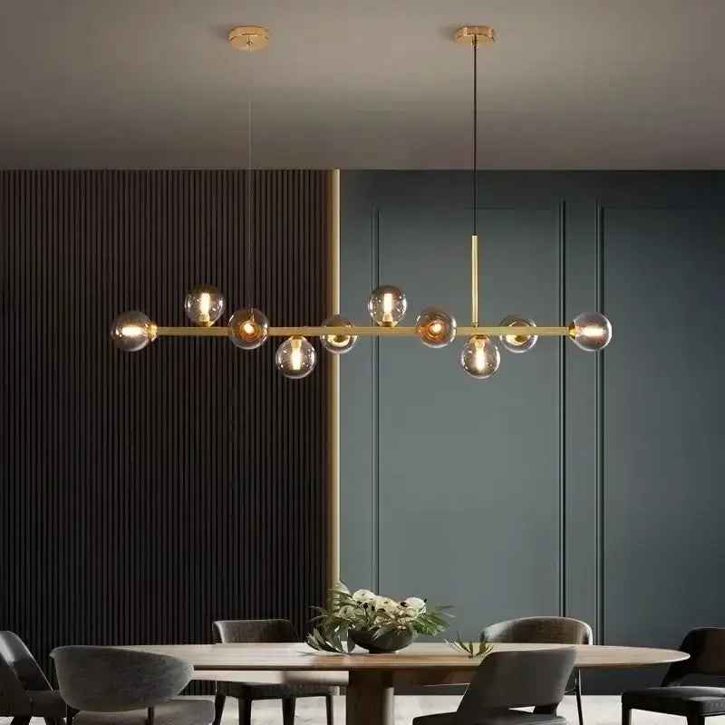 Modern gold glass ball led pendant lights with spherical bulbs suspended from a sleek horizontal bar for dining decorbites