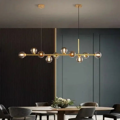 Modern gold glass ball led pendant lights with spherical bulbs suspended from a sleek horizontal bar for dining decorbites