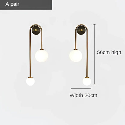 Brass-finished modern wall lamp with two white glass ball LED globes for bedroom and study decorbites glass ball