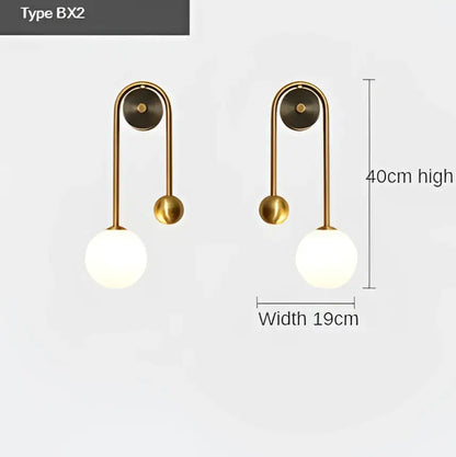 Brass-finished modern wall lamp with curved arm and decorbites glass ball led globe shade for bedroom and study decor
