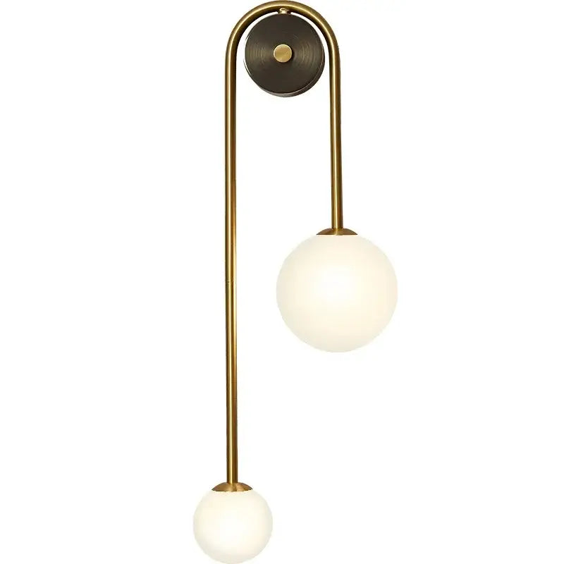 Brass-finished wall lamp with two frosted glass ball led shades ideal for modern bedroom and study decorbites glass ball lighting