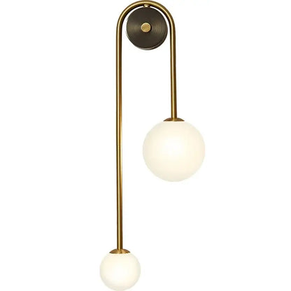Brass-finished wall lamp with two frosted glass ball led shades ideal for modern bedroom and study decorbites glass ball lighting