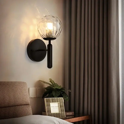 Black wall lamp with textured glass globe shade featuring decorbites glass ball led design for modern bedroom decor