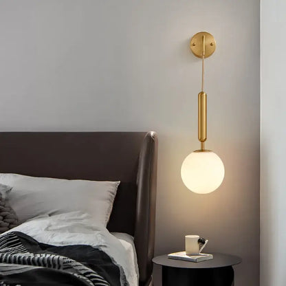 Modern gold glass ball led wall sconce with cylindrical stem and frosted glass shade for bedroom decorbites decor