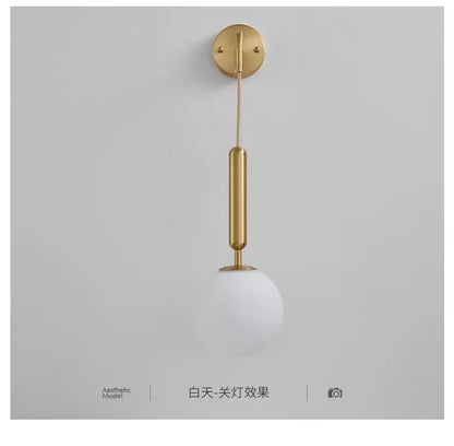 Modern gold glass ball led wall sconce with a sleek cylindrical stem and frosted white shade for bedroom decorbites decor