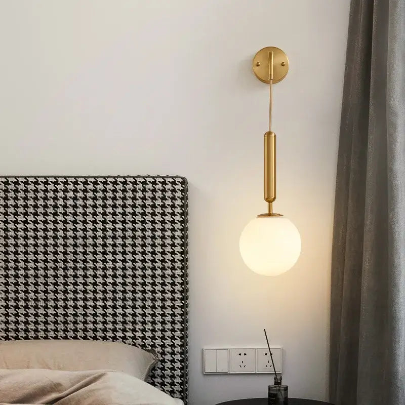 Modern gold glass ball led wall sconce with gold-toned cylindrical stem and frosted glass globe for bedroom decorbites decor
