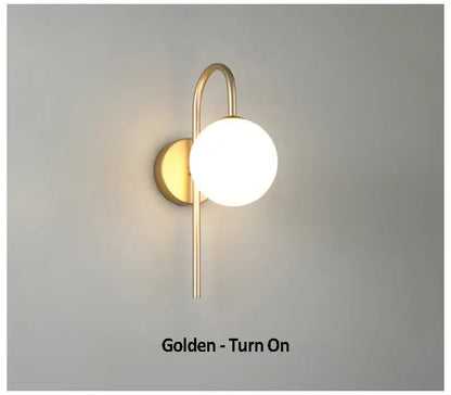Modern gold glass ball led wall sconce with curved metallic arm and frosted glass shade for living room decorbites wall sconce