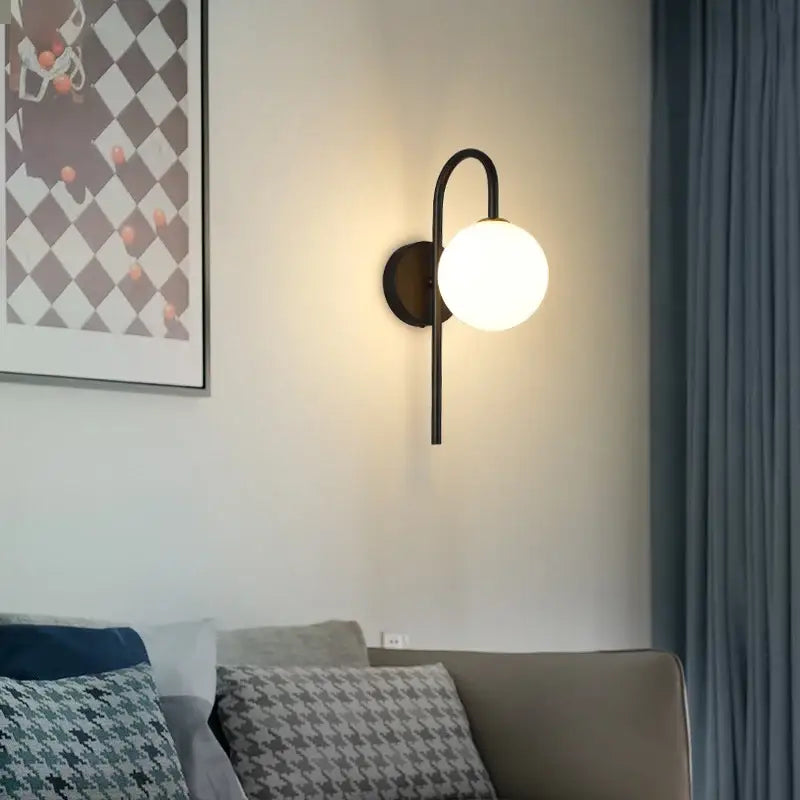 Modern black metal wall sconce with frosted glass globe shade featuring decorbites glass ball led lighting design
