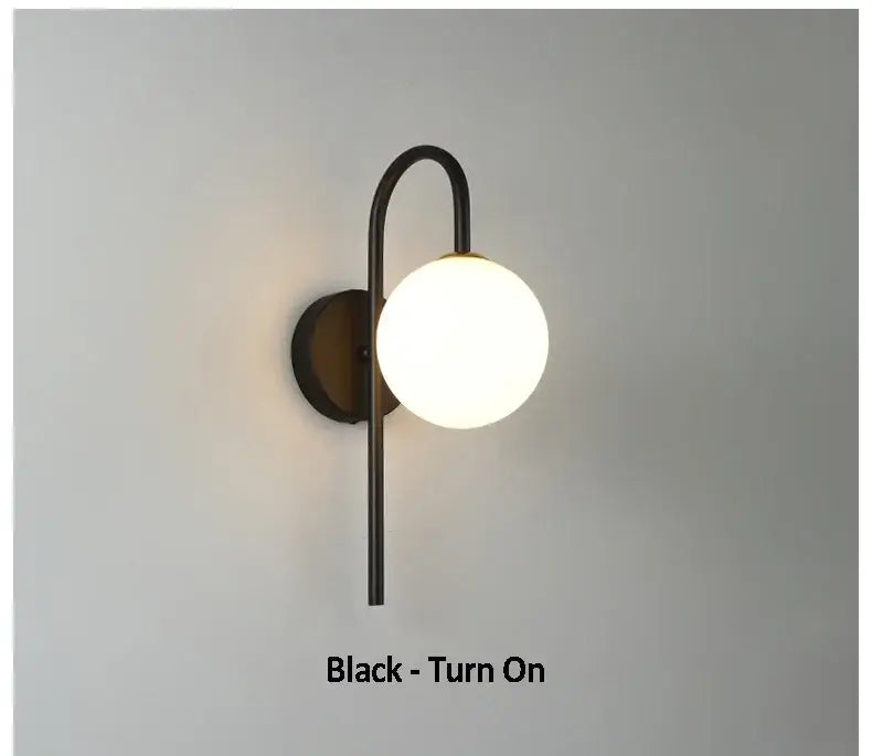 Black metal wall sconce with curved arm and frosted glass globe for decorbites glass ball led living room lighting
