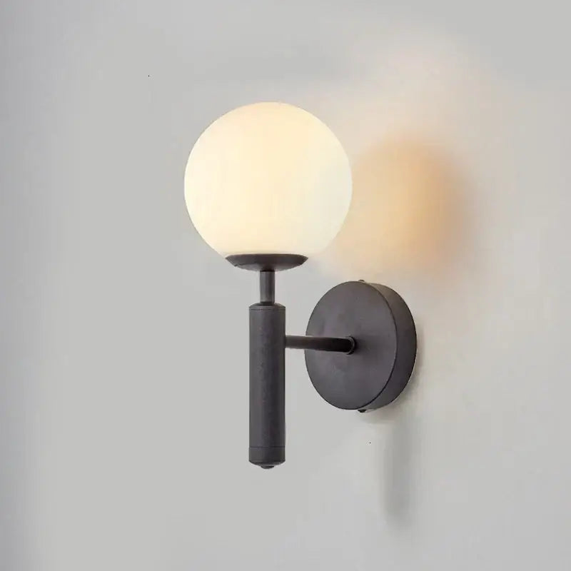 Matte black wall sconce with frosted glass globe for modern wall lights featuring decorbites glass ball mirror design