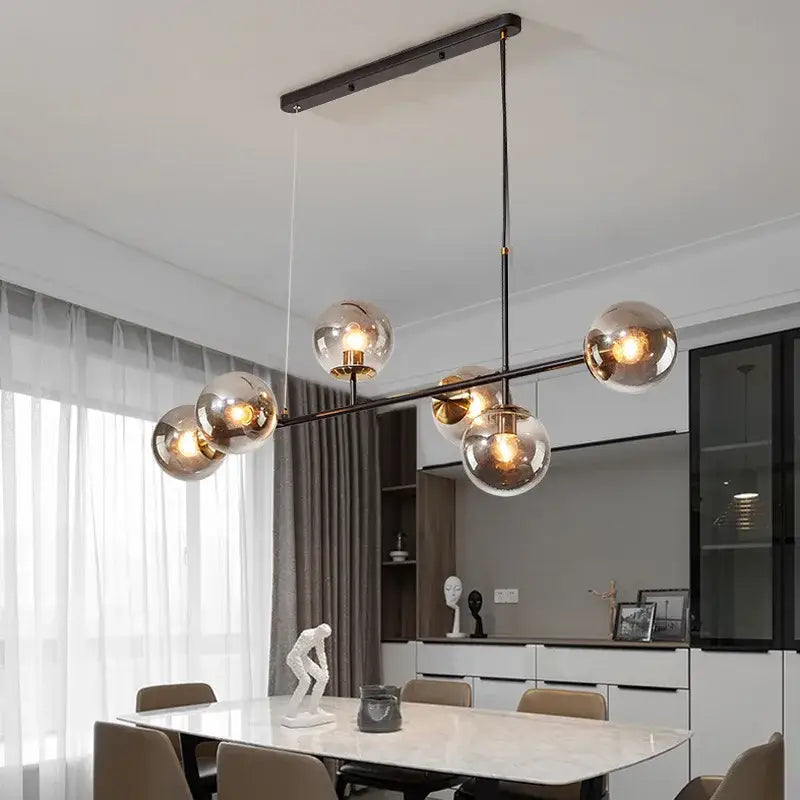 Modern black metal ball pendant chandelier with five spherical glass globes for dining room decorbites glass ball lighting